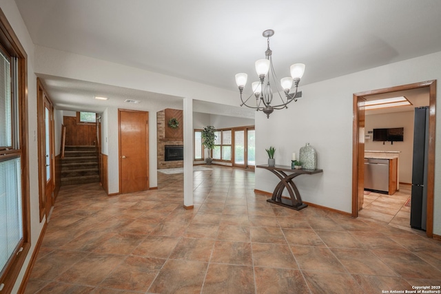 14519 Parksite Woods, San Antonio, TX 78249 - unfurnished dining area with a fireplace, stairway, a chandelier, and stone finish flooring