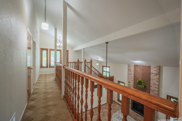 14519 Parksite Woods, San Antonio, TX 78249 - hallway with carpet, an upstairs landing, a textured wall, and a towering ceiling