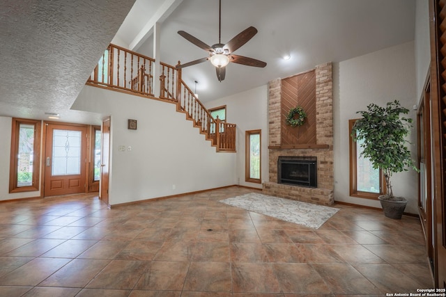 14519 Parksite Woods, San Antonio, TX 78249 - unfurnished living room featuring high vaulted ceiling, stairs, a fireplace, and ceiling fan