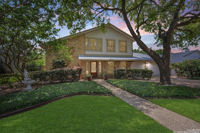 14519 Parksite Woods, San Antonio, TX 78249 - view of front of home with brick siding, a garage, a front lawn, and concrete driveway