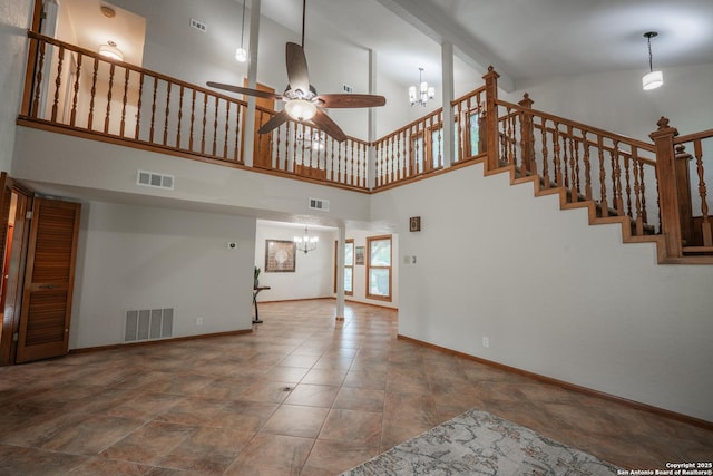 14519 Parksite Woods, San Antonio, TX 78249 - unfurnished living room featuring a chandelier, ceiling fan, a towering ceiling, and stairs