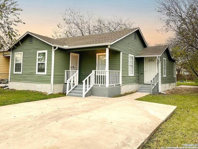 2025 Texas, San Antonio, TX 78228 - bungalow-style house with a porch, a shingled roof, crawl space, and a front yard