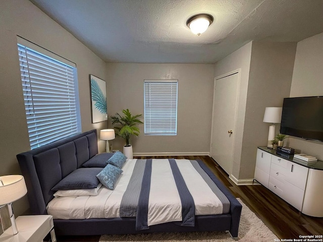 2025 Texas, San Antonio, TX 78228 - bedroom featuring dark wood-style floors and a textured ceiling