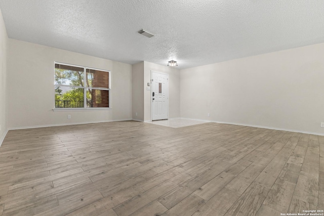 3934 Knollhaven, San Antonio, TX 78247 - spare room with light wood-style flooring and a textured ceiling
