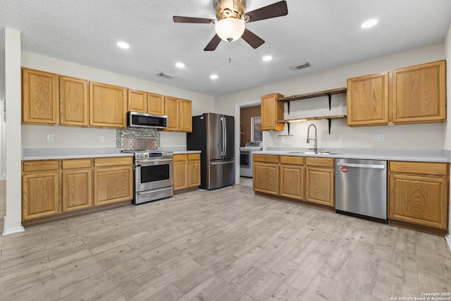 3934 Knollhaven, San Antonio, TX 78247 - kitchen with stainless steel appliances, open shelves, a ceiling fan, light countertops, and a textured ceiling