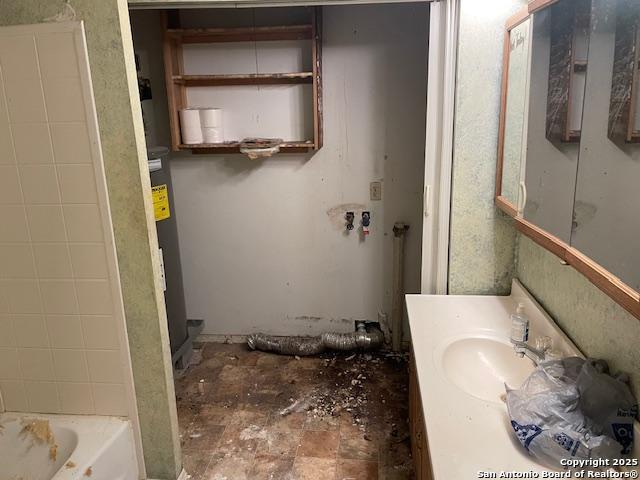 12315 Royal Grn, Conroe, TX 77303 - full bath featuring a bathtub, vanity, and water heater
