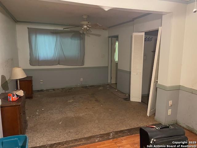 12315 Royal Grn, Conroe, TX 77303 - unfurnished living room featuring a ceiling fan