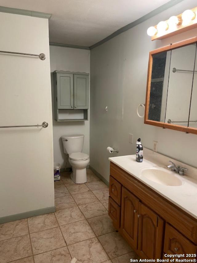 12315 Royal Grn, Conroe, TX 77303 - bathroom featuring vanity, ornamental molding, and tile patterned flooring