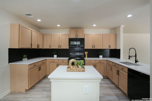 16063 Walnut Crk, San Antonio, TX 78247 - kitchen with black appliances, light brown cabinetry, light wood finished floors, and recessed lighting