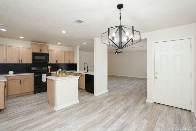 16063 Walnut Crk, San Antonio, TX 78247 - kitchen with black appliances, light countertops, a chandelier, decorative backsplash, and light brown cabinets
