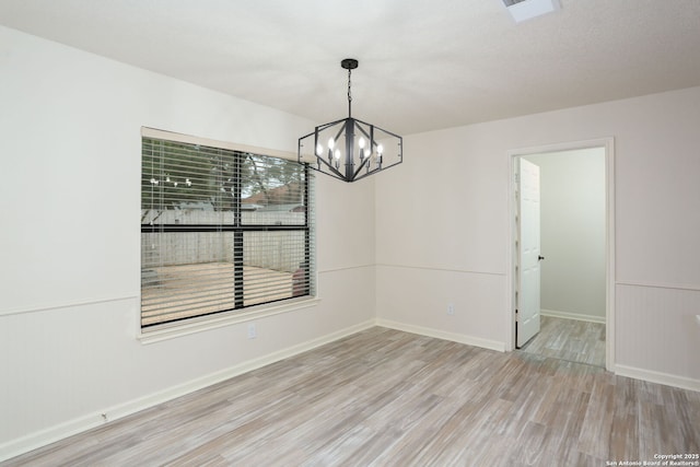 16063 Walnut Crk, San Antonio, TX 78247 - spare room with wood finished floors and a chandelier
