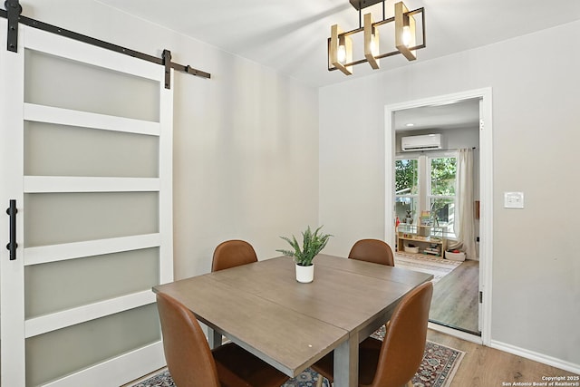 619 Olney Dr, San Antonio, TX 78209 - dining area with a barn door, a wall mounted AC, wood finished floors, and a chandelier