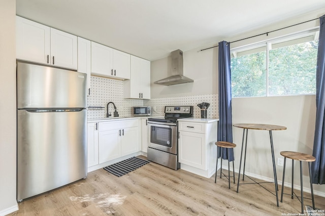 619 Olney Dr, San Antonio, TX 78209 - kitchen featuring appliances with stainless steel finishes, wall chimney exhaust hood, decorative backsplash, and white cabinetry
