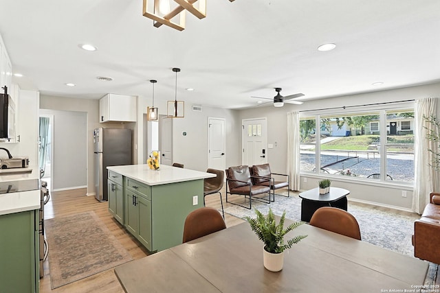 619 Olney Dr, San Antonio, TX 78209 - kitchen with green cabinets, stainless steel appliances, ceiling fan, open floor plan, and light countertops