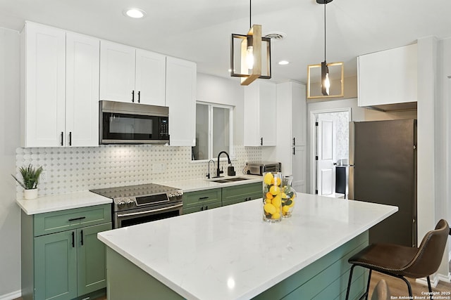 619 Olney Dr, San Antonio, TX 78209 - kitchen with stainless steel appliances, green cabinets, white cabinetry, decorative backsplash, and recessed lighting