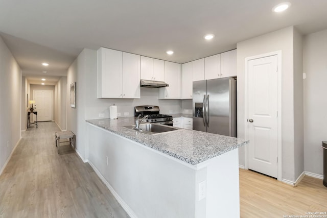 5331 Fair Moon, Bulverde, TX 78163 - kitchen with appliances with stainless steel finishes, under cabinet range hood, light wood-style floors, a peninsula, and white cabinets