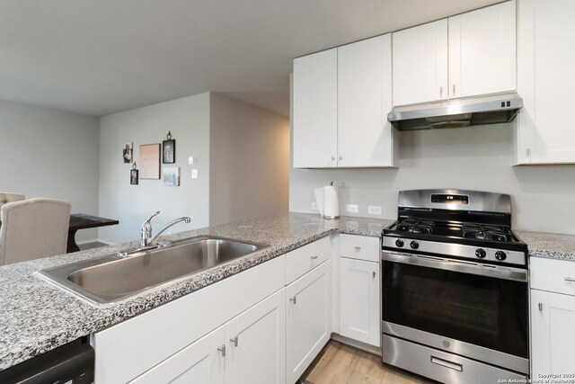 5331 Fair Moon, Bulverde, TX 78163 - kitchen with stainless steel range with gas stovetop, under cabinet range hood, white cabinetry, dishwasher, and light wood-style floors