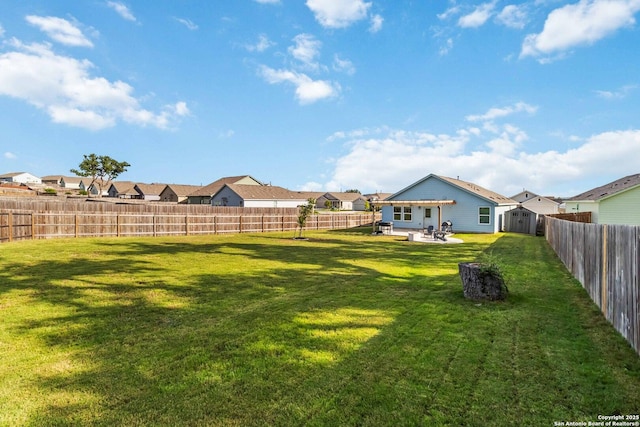 5331 Fair Moon, Bulverde, TX 78163 - fenced backyard featuring a storage unit, a patio area, and a residential view