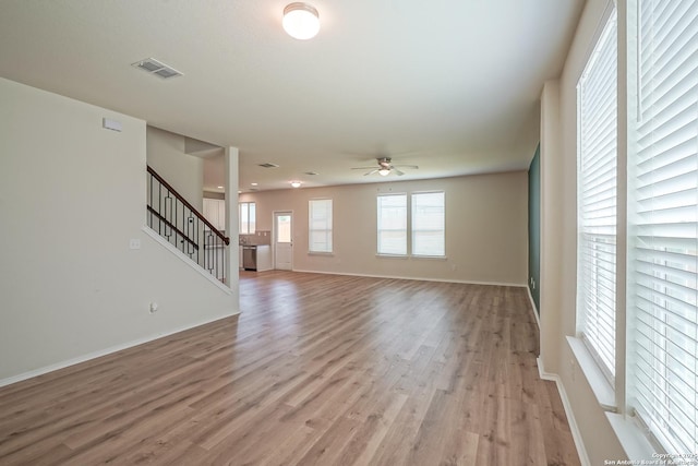 27422 Bighorn Sheep, Boerne, TX 78015 - unfurnished living room with a ceiling fan, light wood-type flooring, and stairway