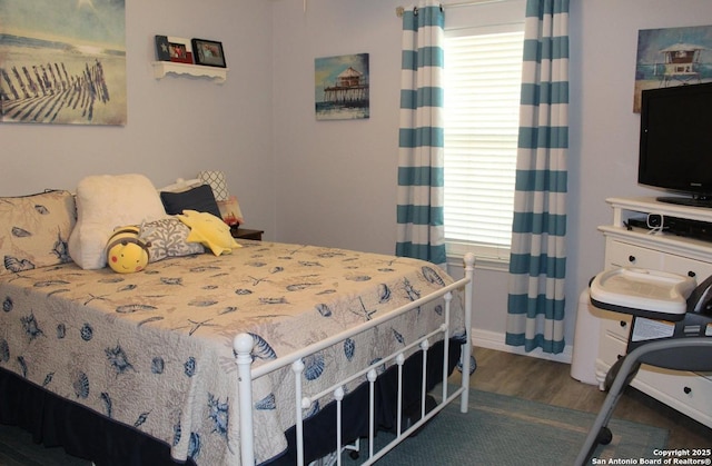 105 Yucca, Jourdanton, TX 78026 - bedroom with multiple windows and wood finished floors