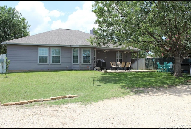 105 Yucca, Jourdanton, TX 78026 - rear view of property featuring a chimney, a patio area, a ceiling fan, and roof with shingles