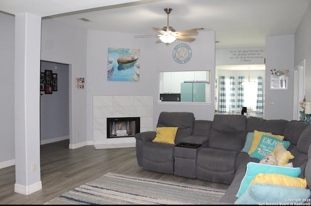 105 Yucca, Jourdanton, TX 78026 - living room featuring wood finished floors, ceiling fan, and a tile fireplace