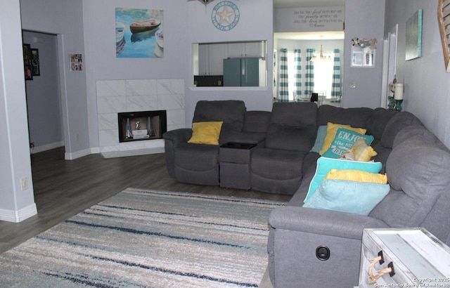 105 Yucca, Jourdanton, TX 78026 - living room featuring wood finished floors and a tiled fireplace