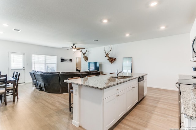 8030 Chanting, San Antonio, TX 78223 - kitchen featuring stove, dishwasher, ceiling fan, light wood-style floors, and white cabinetry