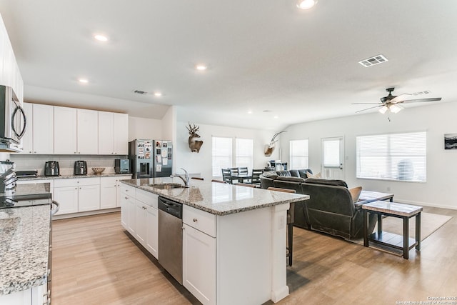 8030 Chanting, San Antonio, TX 78223 - kitchen featuring stainless steel appliances, light wood-style floors, tasteful backsplash, recessed lighting, and a center island with sink