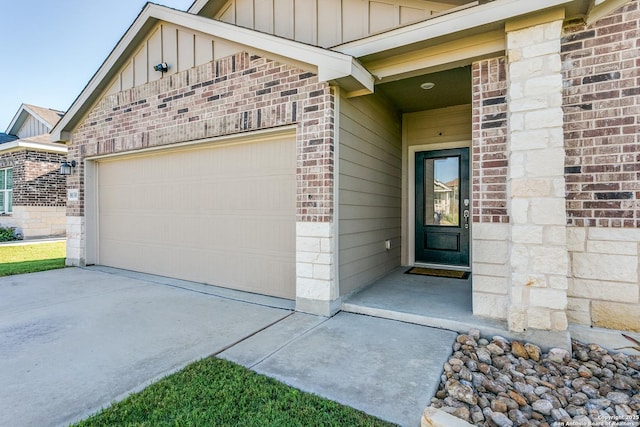 8030 Chanting, San Antonio, TX 78223 - property entrance with board and batten siding, brick siding, concrete driveway, and a garage