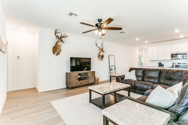 8030 Chanting, San Antonio, TX 78223 - living area with light wood-type flooring, recessed lighting, and a ceiling fan