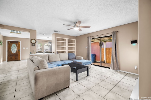 9830 Lauren Mist, San Antonio, TX 78251 - living room with a ceiling fan, light tile patterned floors, a textured ceiling, and a chandelier