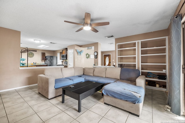 9830 Lauren Mist, San Antonio, TX 78251 - living area featuring ceiling fan, light tile patterned floors, and a textured ceiling