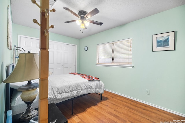 9830 Lauren Mist, San Antonio, TX 78251 - bedroom featuring wood finished floors, a closet, a textured ceiling, and ceiling fan
