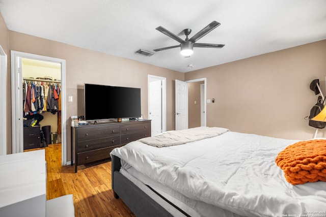9830 Lauren Mist, San Antonio, TX 78251 - bedroom with a spacious closet, wood finished floors, a closet, and ceiling fan