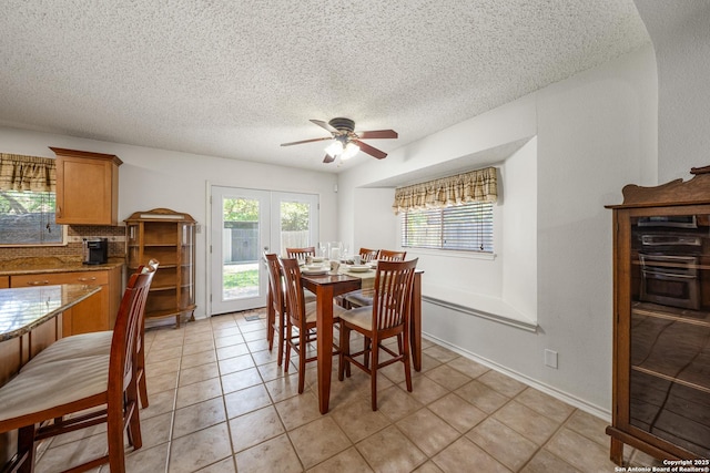 8810 Sebec Cir, San Antonio, TX 78250 - dining space featuring a ceiling fan, a textured ceiling, healthy amount of natural light, and light tile patterned floors