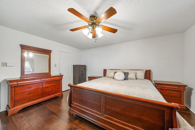 8810 Sebec Cir, San Antonio, TX 78250 - bedroom with dark wood finished floors, a ceiling fan, and a textured ceiling