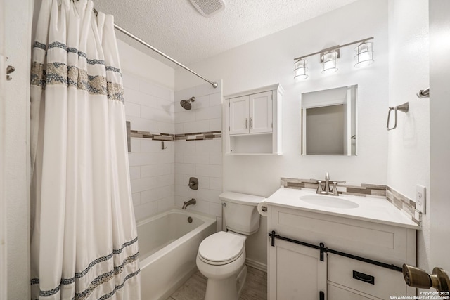 8810 Sebec Cir, San Antonio, TX 78250 - full bath with shower / bath combo with shower curtain, vanity, and a textured ceiling