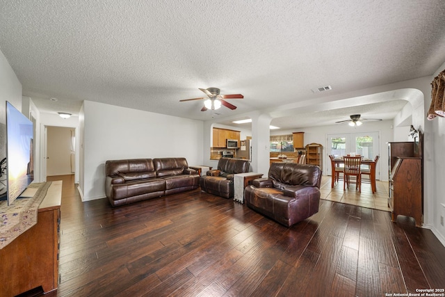 8810 Sebec Cir, San Antonio, TX 78250 - living area featuring ceiling fan, a textured ceiling, and dark wood-style flooring