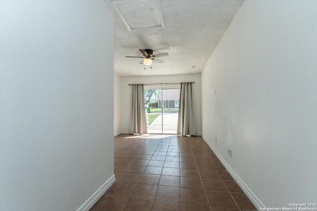 142 Meadow, Converse, TX 78109 - spare room with a textured ceiling, dark tile patterned flooring, and ceiling fan