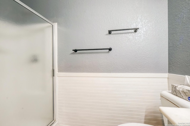 4763 Bending Grv, San Antonio, TX 78259 - bathroom featuring a shower stall and wainscoting