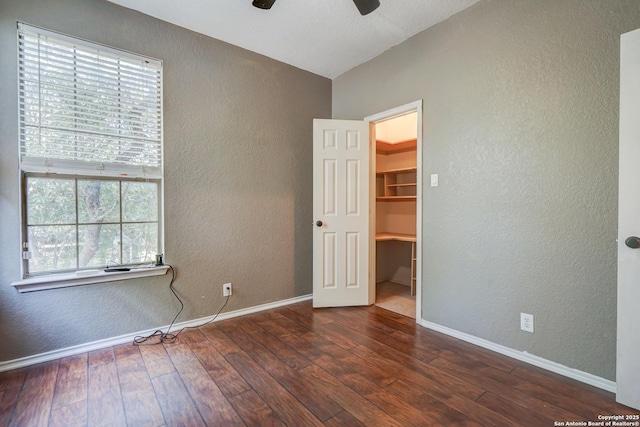 4763 Bending Grv, San Antonio, TX 78259 - unfurnished bedroom featuring a textured wall, multiple windows, wood-type flooring, a walk in closet, and vaulted ceiling