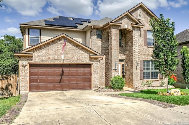 4763 Bending Grv, San Antonio, TX 78259 - view of front of house featuring solar panels, concrete driveway, brick siding, and an attached garage