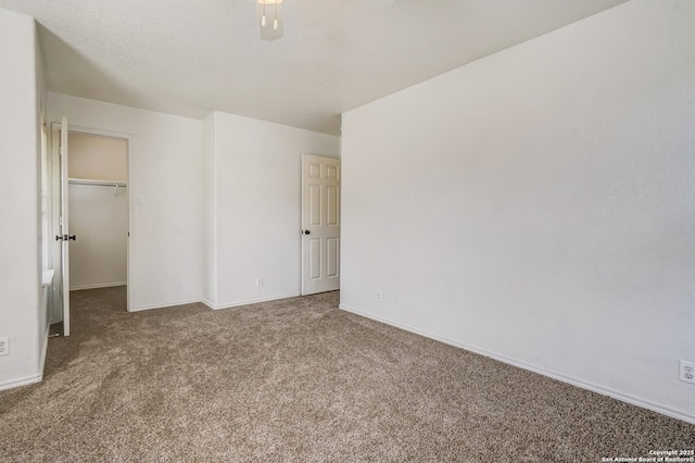 4763 Bending Grv, San Antonio, TX 78259 - unfurnished bedroom featuring carpet flooring, a spacious closet, ceiling fan, and a closet