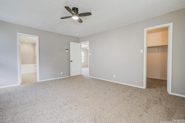 4763 Bending Grv, San Antonio, TX 78259 - unfurnished bedroom with a spacious closet, carpet floors, a closet, ceiling fan, and ensuite bath