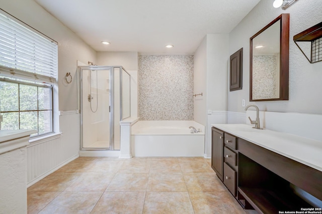 4763 Bending Grv, San Antonio, TX 78259 - bathroom with a garden tub, a stall shower, vanity, tile patterned flooring, and wainscoting