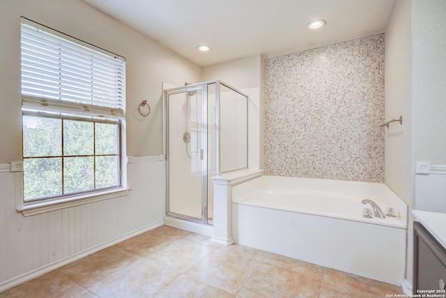 4763 Bending Grv, San Antonio, TX 78259 - bathroom featuring a bath, a stall shower, tile patterned floors, wainscoting, and vanity