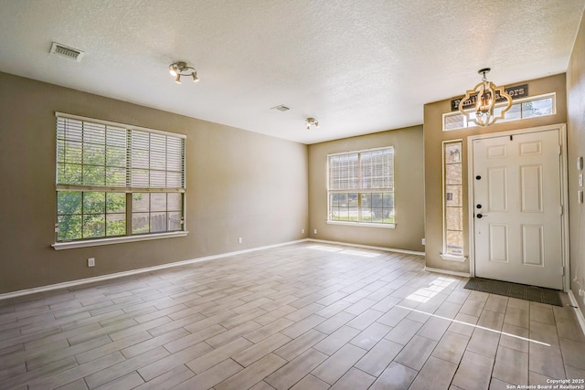 4763 Bending Grv, San Antonio, TX 78259 - foyer entrance featuring a textured ceiling, a chandelier, and wood finished floors