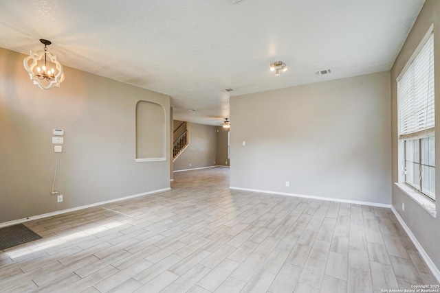 4763 Bending Grv, San Antonio, TX 78259 - spare room featuring stairway, light wood-style flooring, and healthy amount of natural light