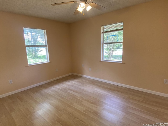 305 Osage, Refugio, TX 78377 - empty room with a textured ceiling, light wood-type flooring, and ceiling fan